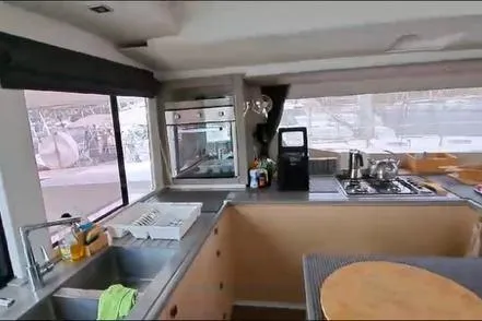 Sanouva Yacht Photos Pics Modern kitchen interior of 2019 Fountaine Pajot SABA 50 catamaran with appliances and large windows.