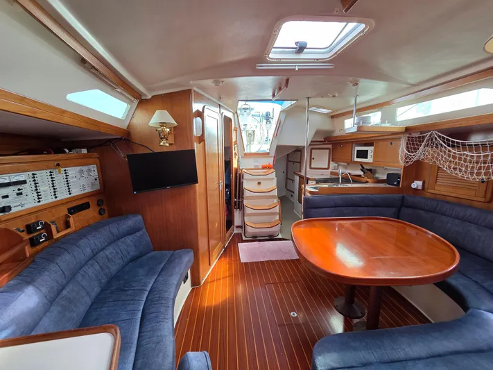 Yacht Photos Pics Interior of 2000 Catalina 42 MkII sailboat with wood finish and blue seating.