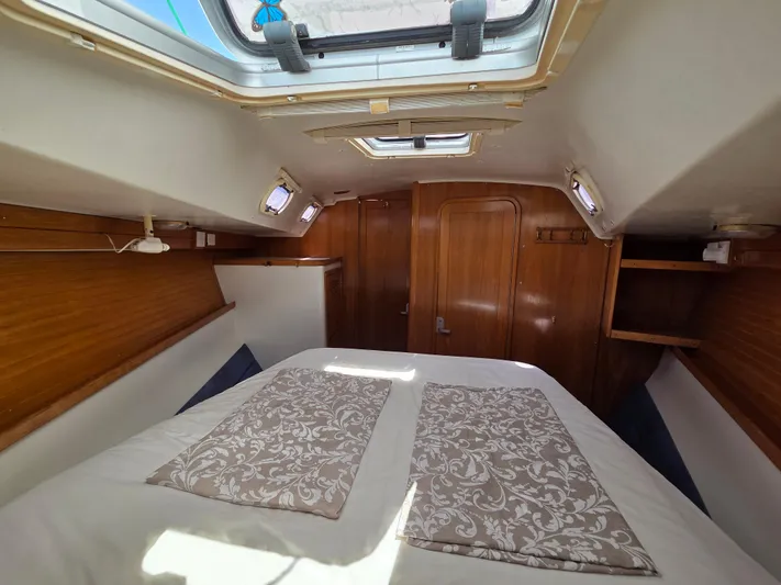  Yacht Photos Pics Cozy cabin interior of 2000 Catalina 42 MkII sailboat with skylight and wooden accents.