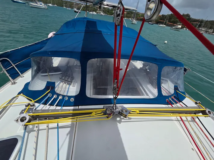  Yacht Photos Pics Catalina 42 MkII sailboat deck with blue canopy and rigging, anchored in a marina.