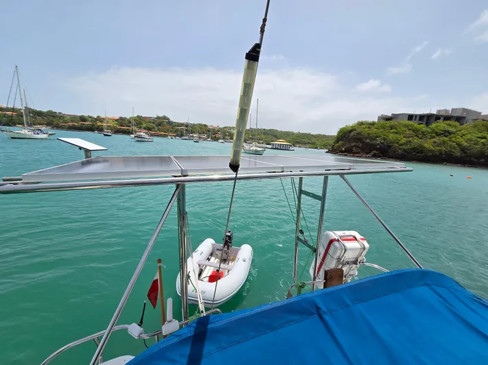  Yacht Photos Pics Sailboat with solar panels and dinghy in a scenic marina, Catalina 42 MkII, 2000 model.
