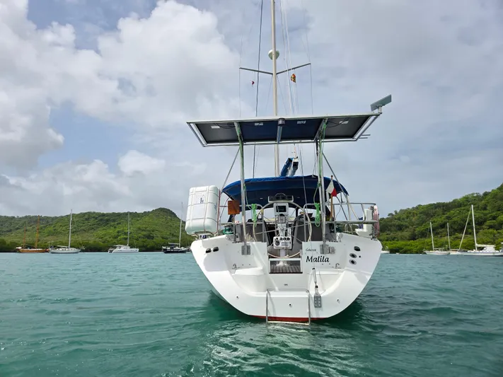  Yacht Photos Pics Catalina 42 MkII sailboat from 2000 anchored in scenic bay with lush hills.