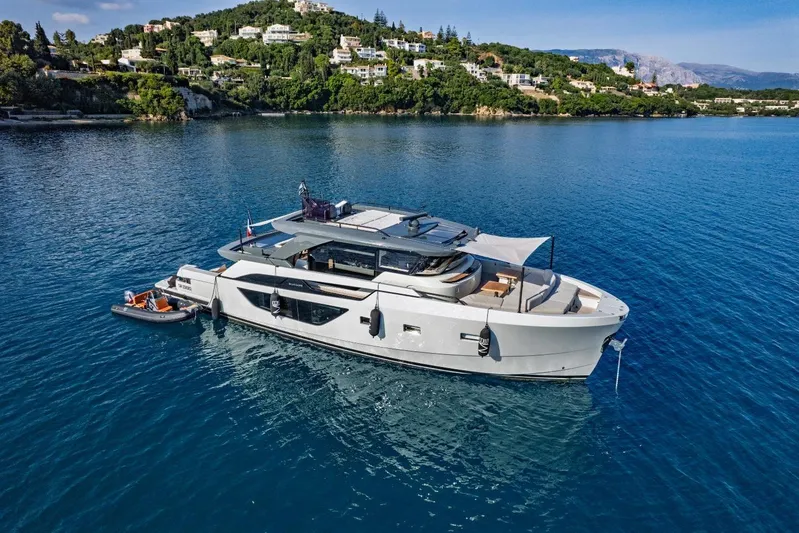 M8-15 Yacht Photos Pics 2023 Bluegame BGX 63 yacht anchored in scenic coastal waters.