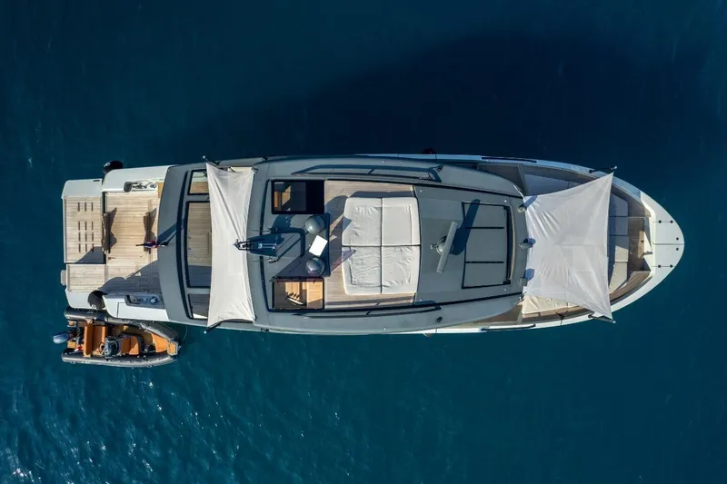 M8-15 Yacht Photos Pics Aerial view of 2023 Bluegame BGX 63 yacht on blue water.