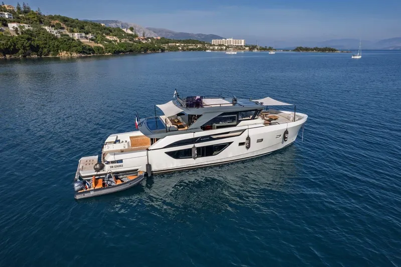 M8-15 Yacht Photos Pics 2023 Bluegame BGX 63 yacht anchored in serene coastal waters.