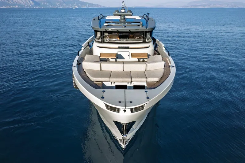 M8-15 Yacht Photos Pics 2023 Bluegame BGX 63 yacht on calm sea, showcasing sleek design and spacious deck.