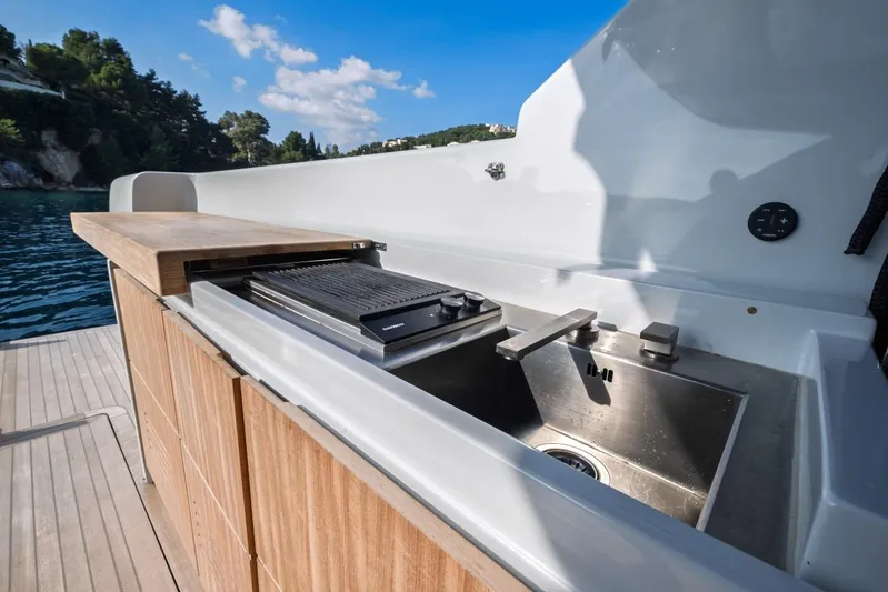 M8-15 Yacht Photos Pics Outdoor kitchen on 2023 Bluegame BGX 63 yacht with sink and grill.