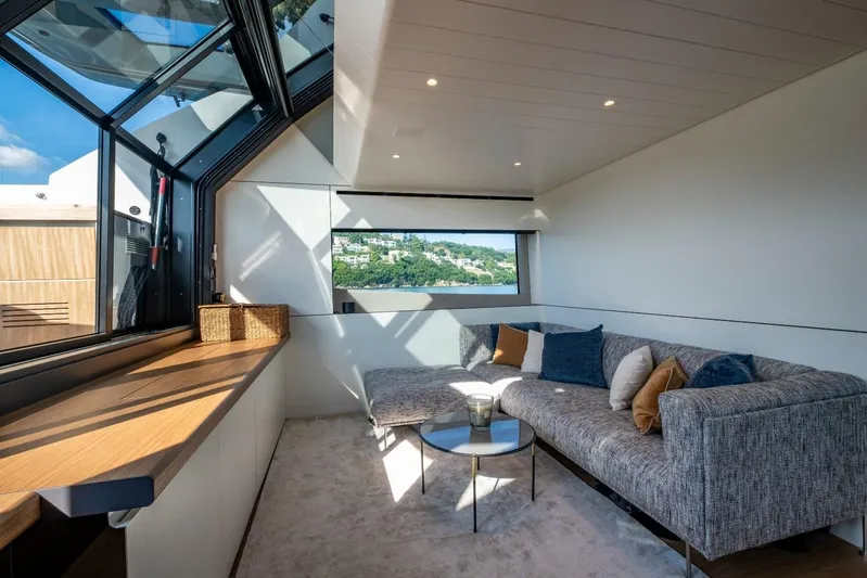 M8-15 Yacht Photos Pics Luxurious interior of 2023 Bluegame BGX 63 yacht with modern seating and panoramic windows.