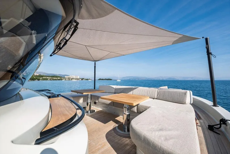 M8-15 Yacht Photos Pics Luxurious 2023 Bluegame BGX 63 yacht deck with seating, table, and sunshade on open sea.