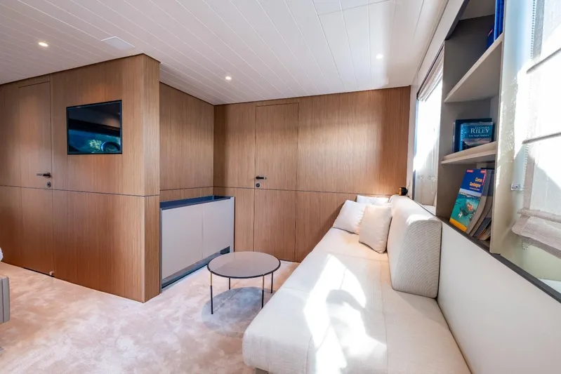 M8-15 Yacht Photos Pics Luxurious interior of 2023 Bluegame BGX 63 yacht with modern wood paneling and cozy seating.