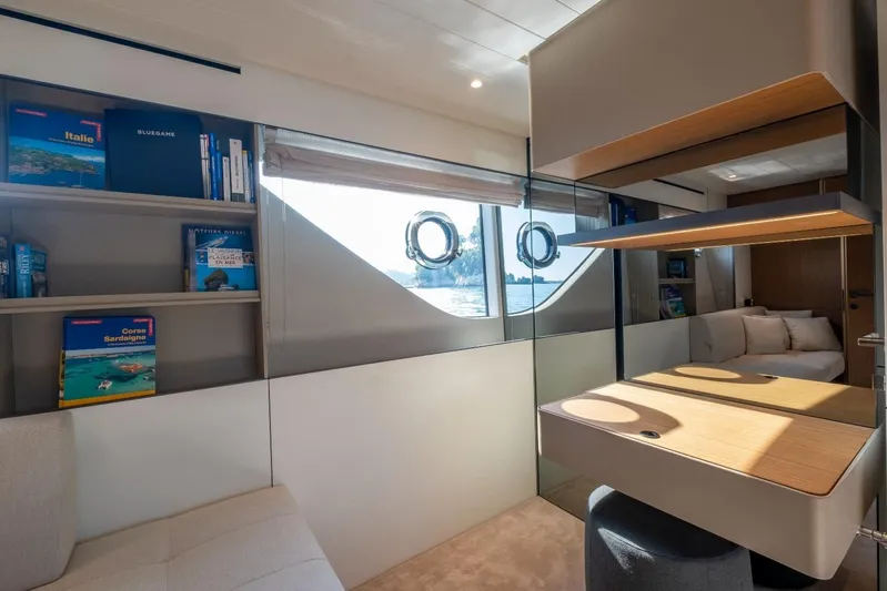 M8-15 Yacht Photos Pics Luxurious interior of 2023 Bluegame BGX 63 yacht with modern furnishings and scenic window view.