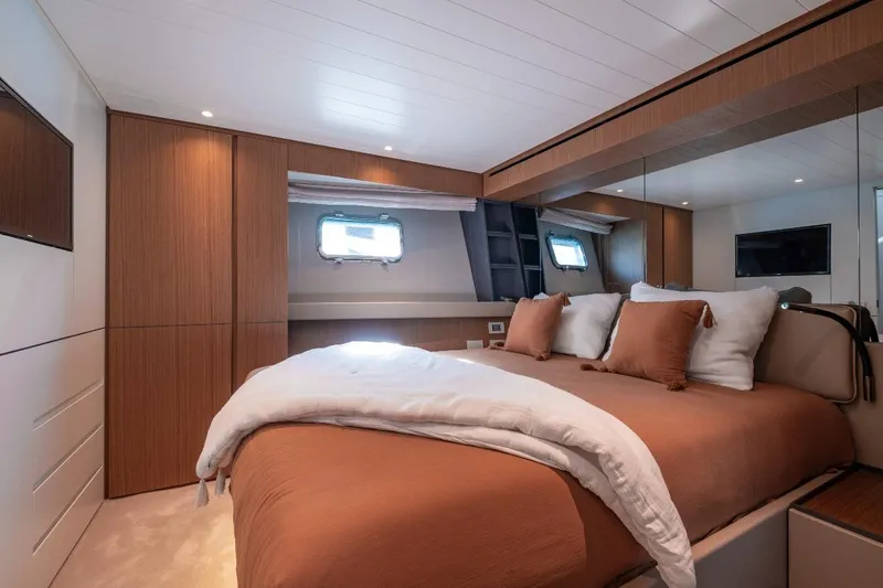 M8-15 Yacht Photos Pics Luxurious bedroom interior of 2023 Bluegame BGX 63 yacht with modern design and cozy bedding.