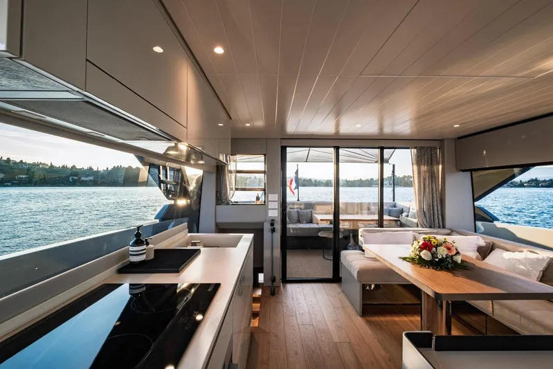 M8-15 Yacht Photos Pics Luxurious interior of 2023 Bluegame BGX 63 yacht with modern kitchen and elegant seating area.