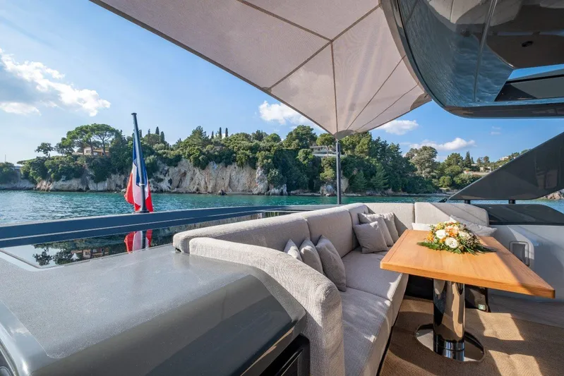 M8-15 Yacht Photos Pics Luxurious 2023 Bluegame BGX 63 yacht deck with elegant seating and scenic coastal view.