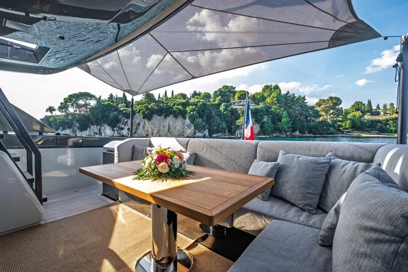 M8-15 Yacht Photos Pics Luxurious 2023 Bluegame BGX 63 yacht deck with elegant seating and scenic coastal view.