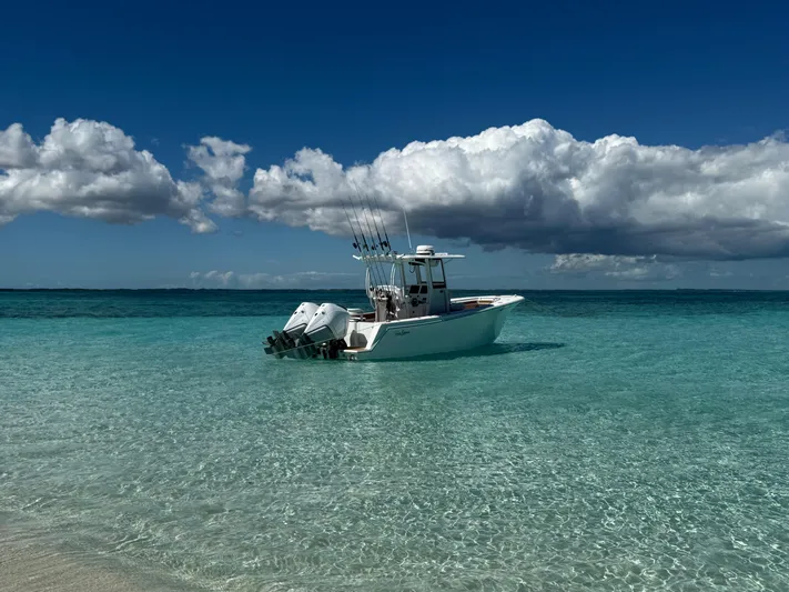  Yacht Photos Pics 2025 Pair Customs 28 Center Console boat on clear turquoise water under a cloudy sky.