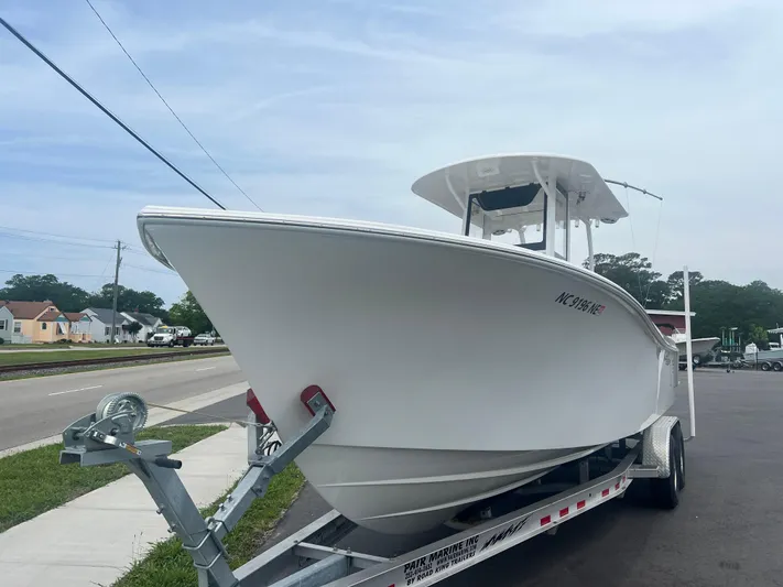  Yacht Photos Pics 2025 Pair Customs 28 Center Console boat on trailer, parked on roadside.