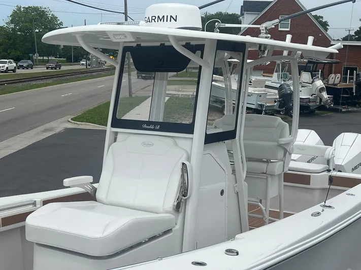  Yacht Photos Pics 2025 Pair Customs 28 Center Console boat with Garmin equipment, docked near a road.