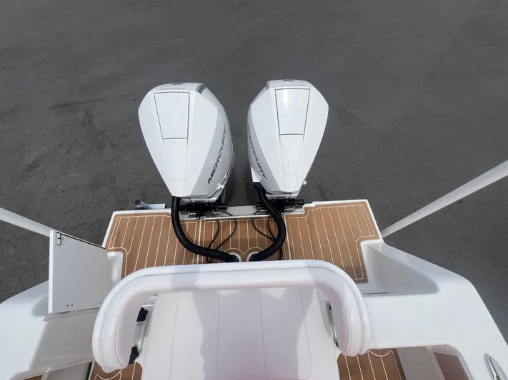  Yacht Photos Pics 2025 Pair Customs 28 Center Console with dual outboard motors on deck.