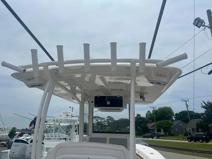  Yacht Photos Pics 2025 Pair Customs 28 Center Console boat with rod holders and canopy, docked near residential area.