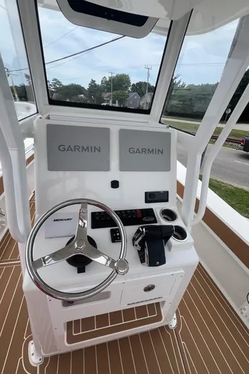  Yacht Photos Pics 2025 Pair Customs 28 Center Console boat dashboard with dual Garmin displays and steering wheel.