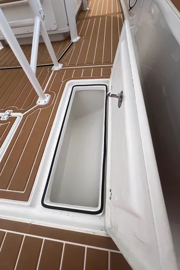  Yacht Photos Pics 2025 Pair Customs 28 Center Console boat with open storage compartment on deck.