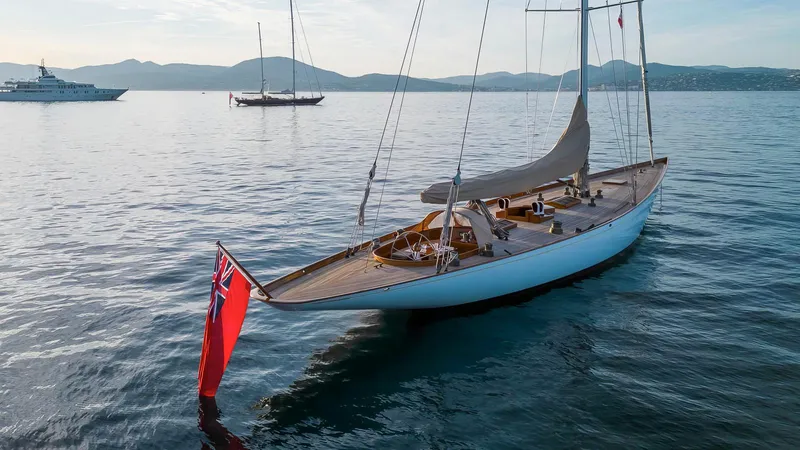 Savannah Yacht Photos Pics Sailing yacht Concordia Custom Pedrick Design Sloop, 1996, on calm waters with scenic backdrop.