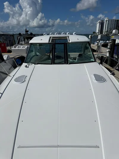  Yacht Photos Pics 2009 Cruisers Yachts 390 Sports Coupe docked under a cloudy sky.