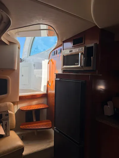  Yacht Photos Pics Interior of 2009 Cruisers Yachts 390 Sports Coupe with kitchen appliances and steps to deck.