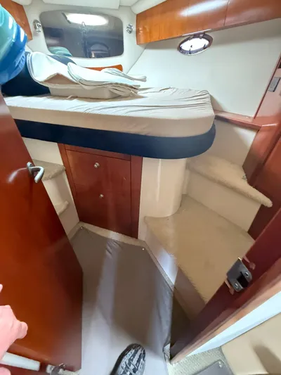  Yacht Photos Pics 2009 Cruisers Yachts 390 Sports Coupe cabin interior with bed and wooden cabinetry.