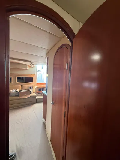  Yacht Photos Pics Interior view of 2009 Cruisers Yachts 390 Sports Coupe, featuring wooden doors and cozy seating area.