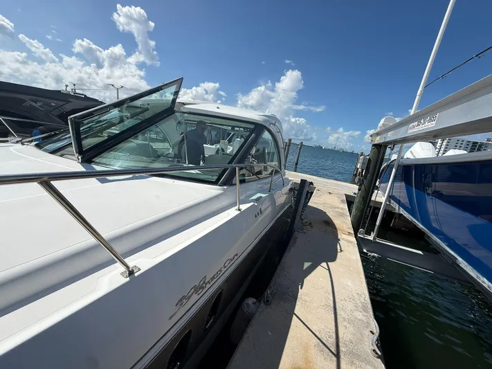  Yacht Photos Pics 2009 Cruisers Yachts 390 Sports Coupe docked by the water on a sunny day.