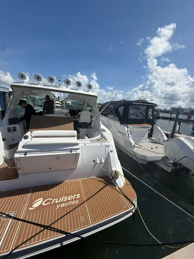  Yacht Photos Pics 2009 Cruisers Yachts 390 Sports Coupe docked under a clear blue sky.