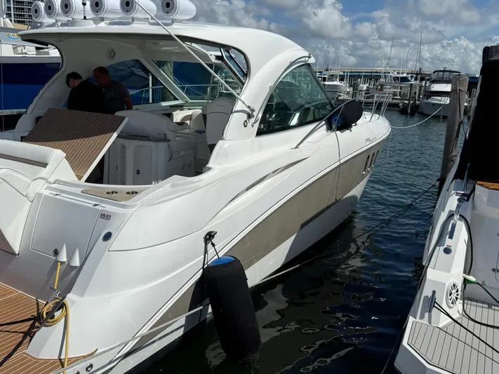  Yacht Photos Pics 2009 Cruisers Yachts 390 Sports Coupe docked at marina under blue sky.