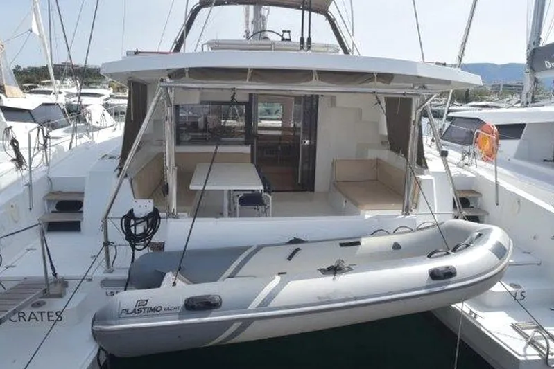  Yacht Photos Pics 2016 Bali 4.5 catamaran with dinghy, docked at marina, featuring spacious deck and seating area.