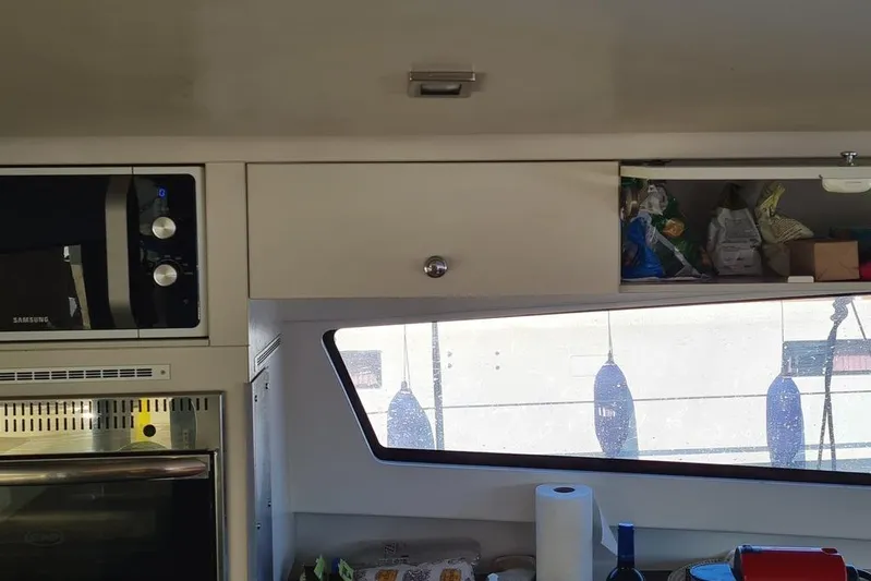  Yacht Photos Pics Interior of a 2016 Bali 4.5 catamaran kitchen with microwave and storage.