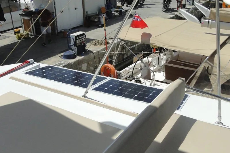  Yacht Photos Pics 2016 Bali 4.5 yacht with solar panels and a red flag at the dock.
