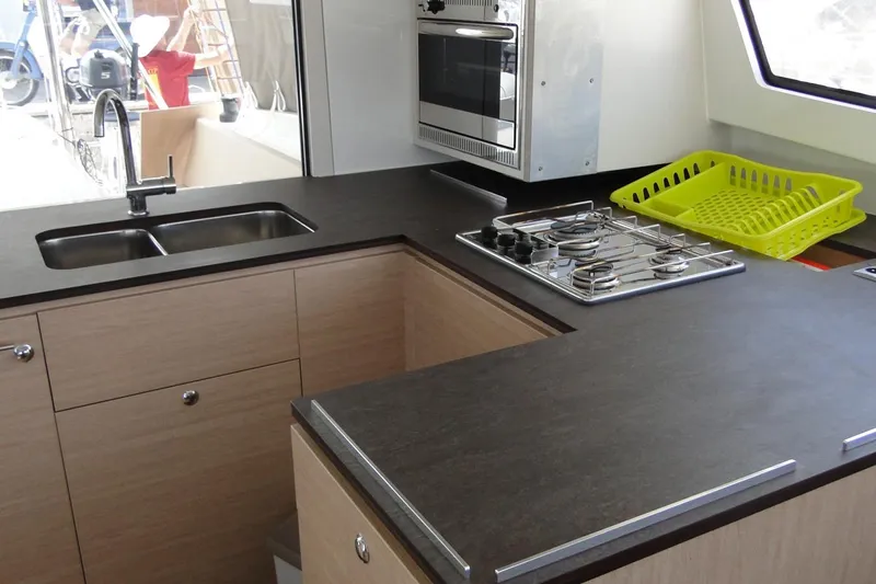  Yacht Photos Pics Modern kitchen in a 2016 Bali 4.5 yacht with stove, sink, and countertop.