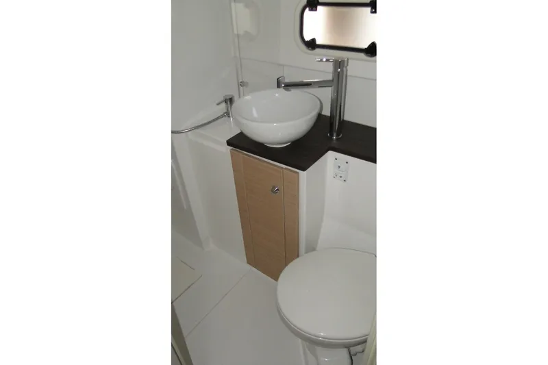  Yacht Photos Pics Compact bathroom in 2016 Bali 4.5 model, featuring modern sink and toilet.