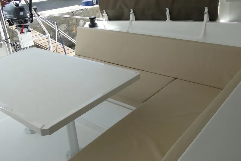  Yacht Photos Pics Outdoor seating area on a 2016 Bali 4.5 yacht with beige cushions and table.
