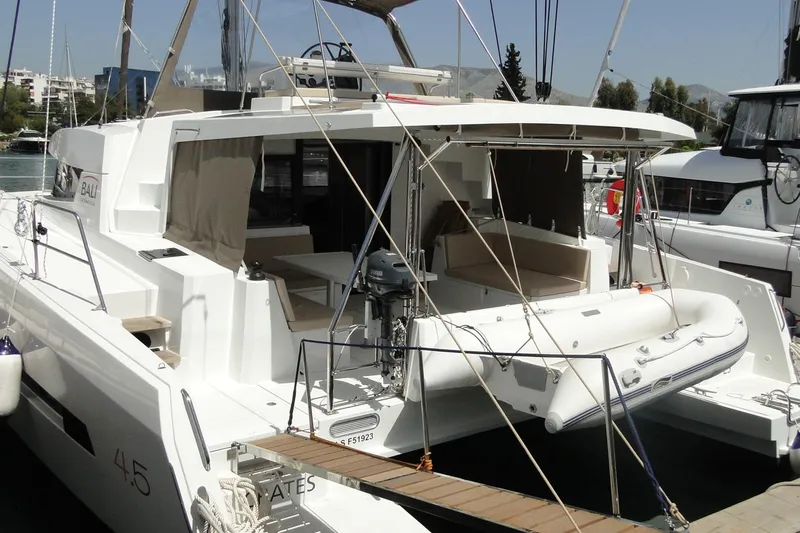  Yacht Photos Pics 2016 Bali 4.5 catamaran docked, featuring spacious deck and inflatable dinghy.