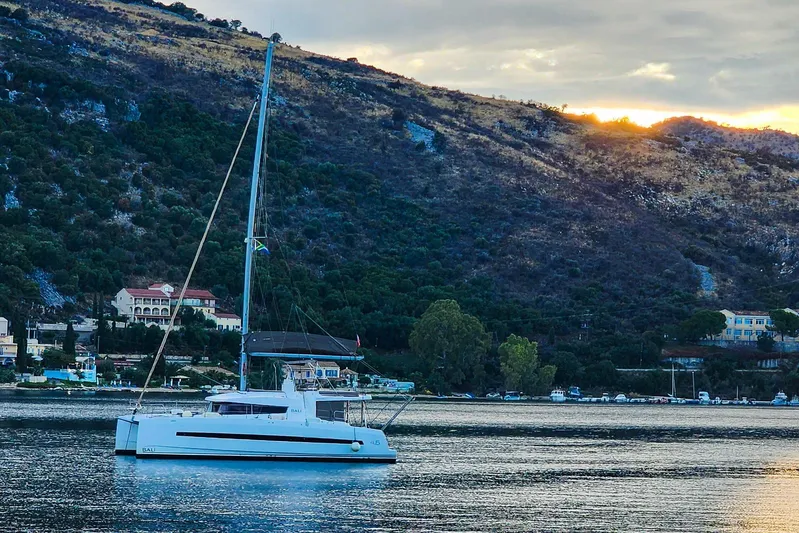  Yacht Photos Pics Sailboat Bali 4.5 (2016) anchored near scenic hillside at sunset.