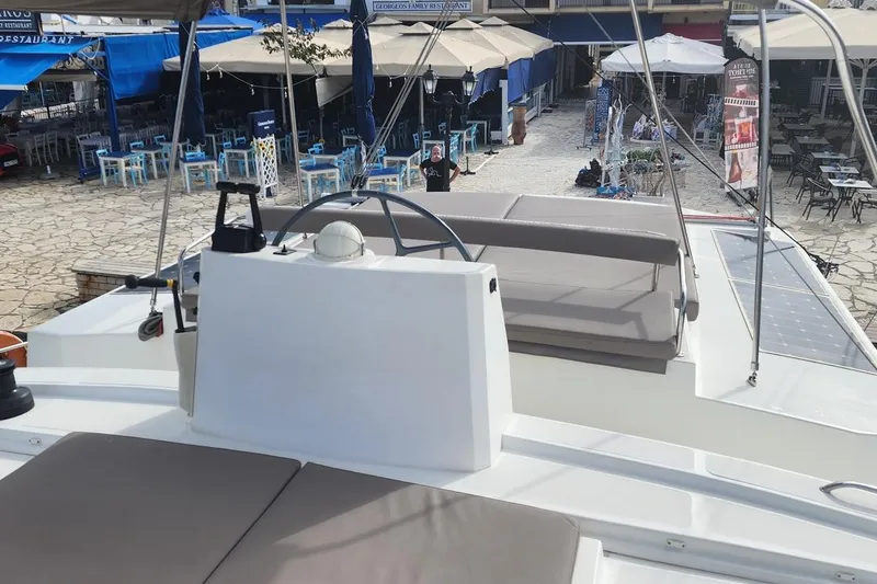  Yacht Photos Pics Helm of 2016 Bali 4.5 catamaran docked near outdoor restaurant seating.