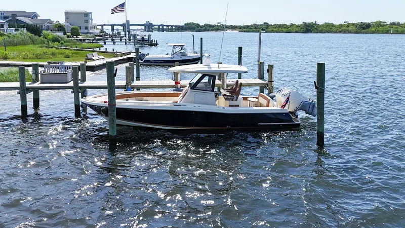 Rest Assured Yacht Photos Pics 2019 Chris-Craft 30 Catalina docked on a sunny waterfront.