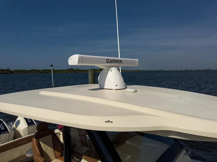 Rest Assured Yacht Photos Pics 2019 Chris-Craft 30 Catalina with Garmin radar on roof, docked by the water.