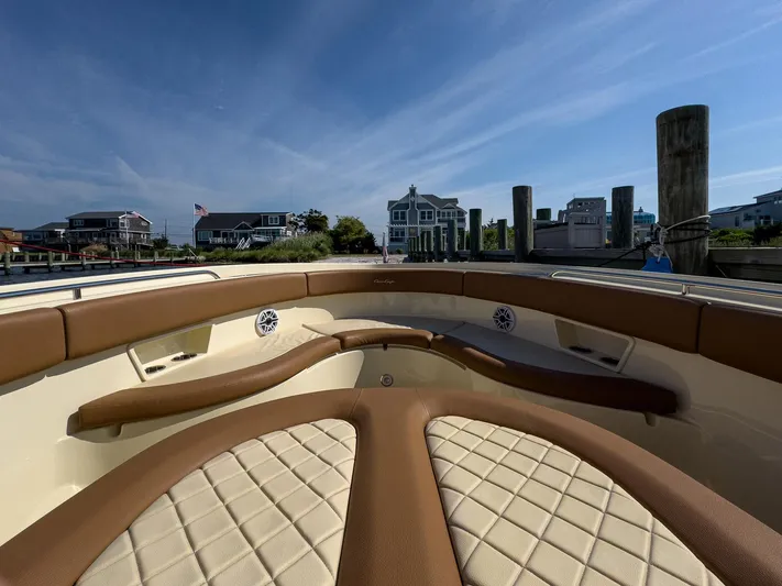 Rest Assured Yacht Photos Pics 2019 Chris-Craft 30 Catalina boat interior with tan leather seating at a dock.