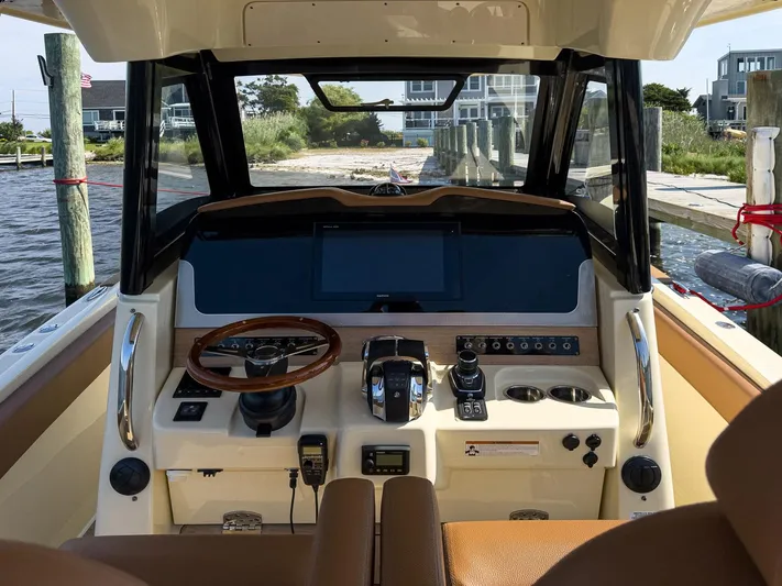 Rest Assured Yacht Photos Pics 2019 Chris-Craft 30 Catalina helm with modern controls and navigation system.