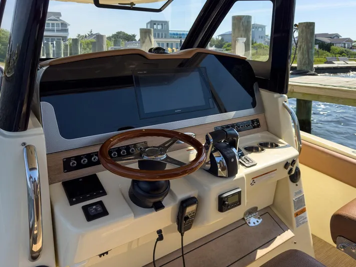 Rest Assured Yacht Photos Pics 2019 Chris-Craft 30 Catalina helm with modern controls and wooden steering wheel.