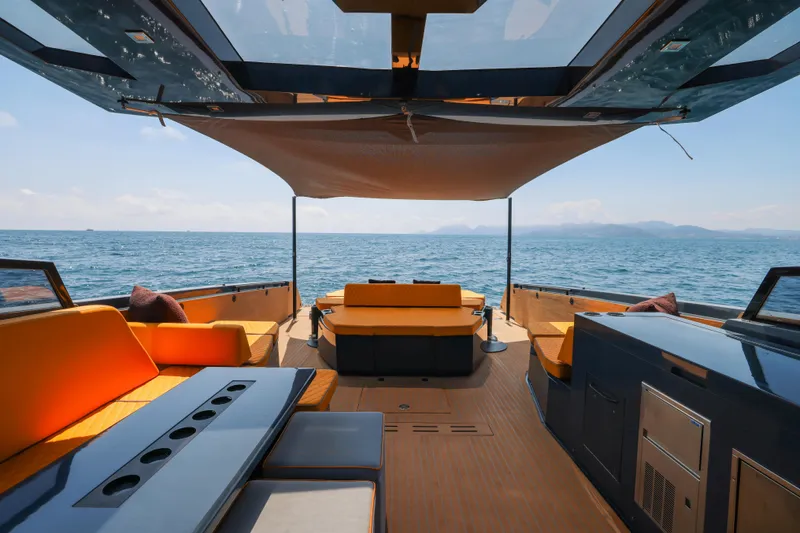 Gustavia I Yacht Photos Pics Luxurious 2021 OKEAN 55 yacht interior with ocean view, featuring modern seating and canopy.