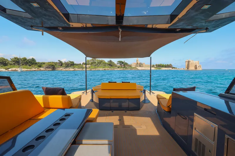 Gustavia I Yacht Photos Pics Luxurious 2021 OKEAN 55 yacht interior with vibrant seating, overlooking serene coastal waters.